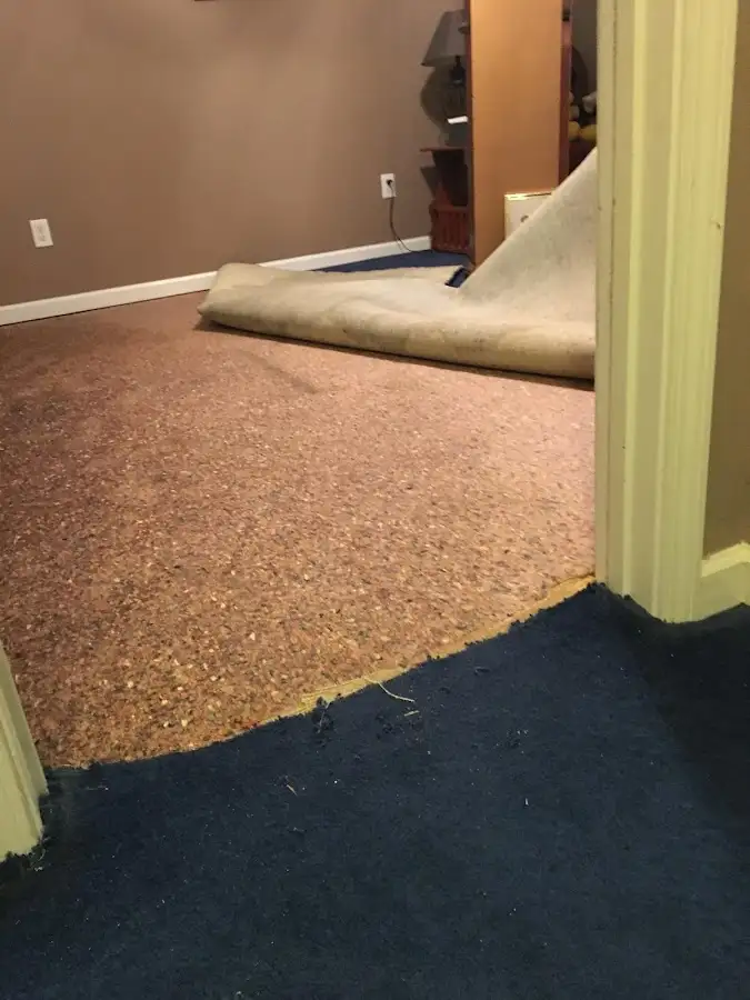 Carpet pad removal revealing water damage during Water Mitigation Services in Stonecrest